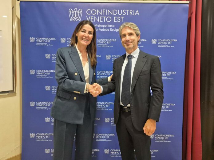Gianni Canella con Paola Carron davanti al logo di Confindustria Veneto Est